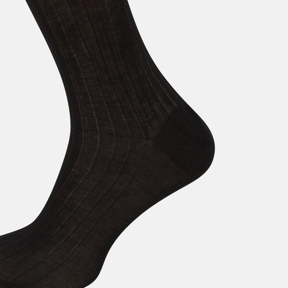 A single Turnbull & Asser Black Cotton Long Sock is shown upright on a white background, featuring a ribbed texture along the leg and foot with a smooth finish at the top.