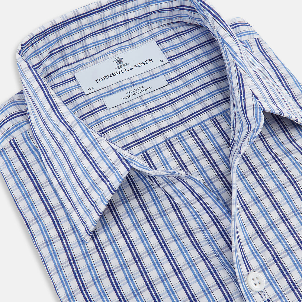 Turnbull & Asser's Blue and Navy Multi Check Piccadilly Shirt features long sleeves, a pointed collar, and two buttoned chest pockets, shown on a white background.