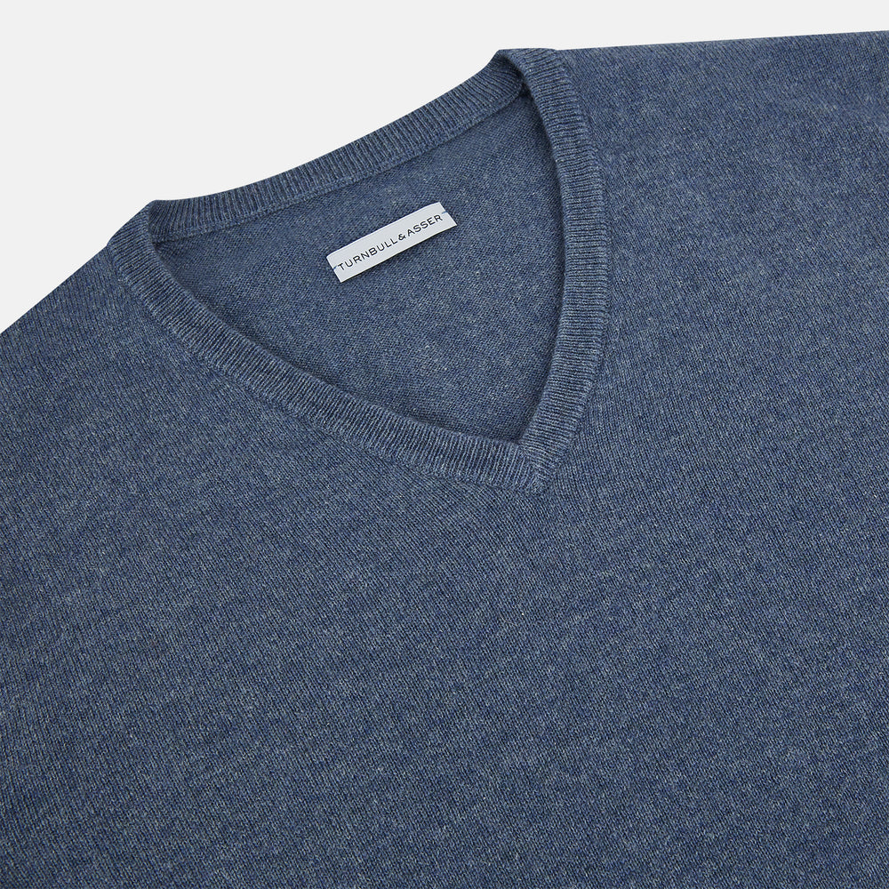 The Blue Melange Cashmere V-neck Jumper by Turnbull & Asser, featuring ribbed cuffs and hem, is part of our knitwear collection and shown against a white background.