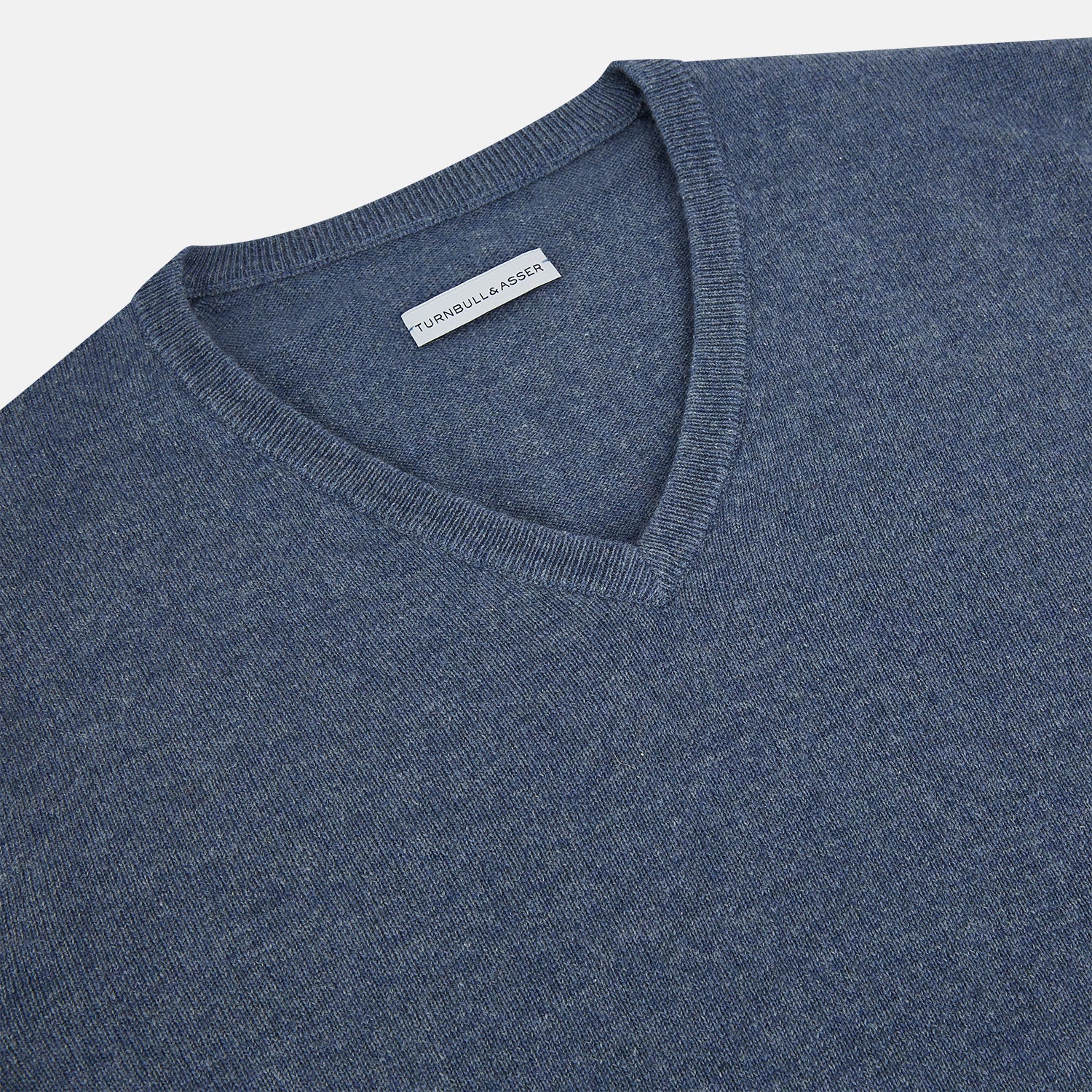 View 2 of product The Blue Melange Cashmere V-neck Jumper by Turnbull & Asser, featuring ribbed cuffs and hem, is part of our knitwear collection and shown against a white background.