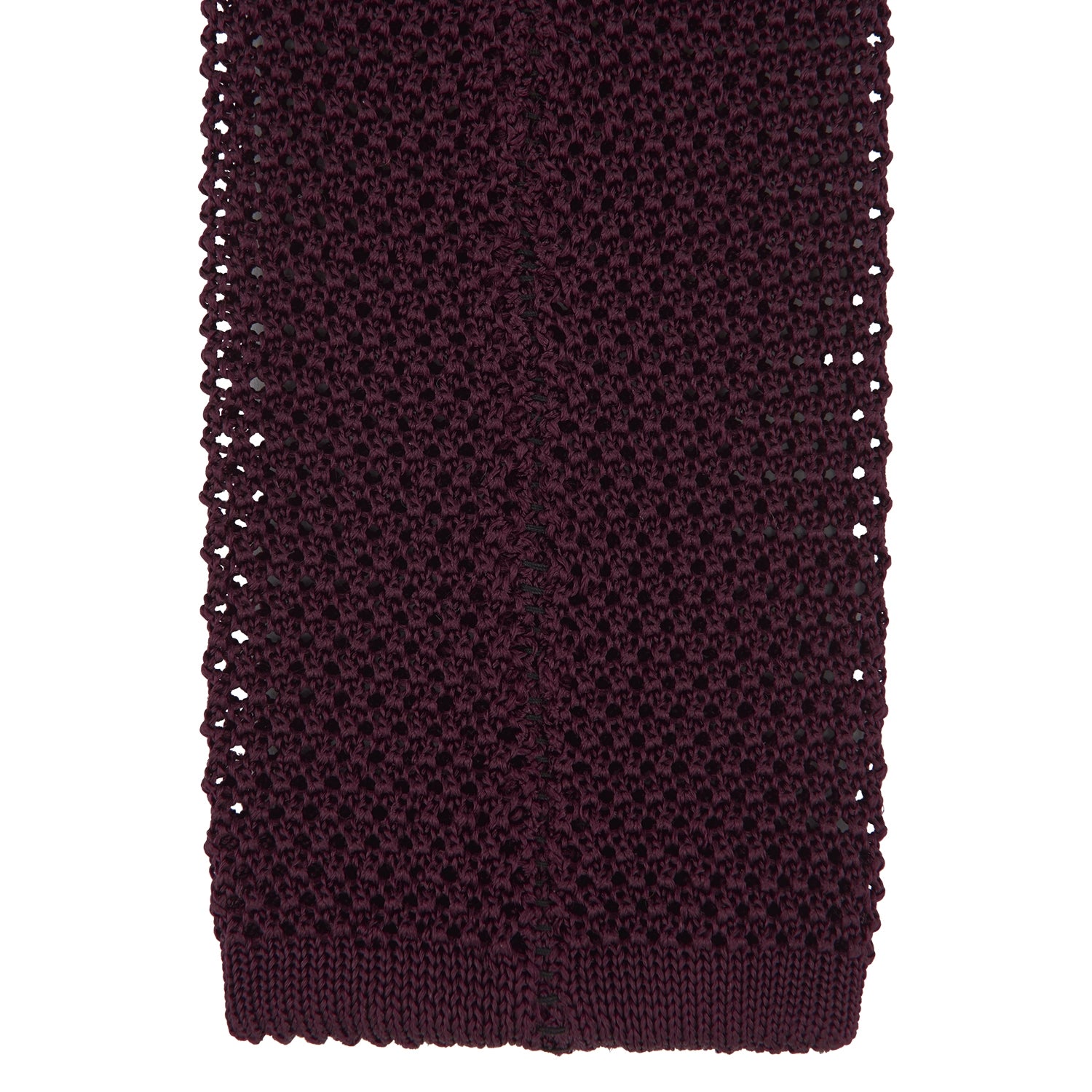 View 4 of product The Turnbull & Asser MTIE011-ZAI003 TIES 7.5CM is a plain burgundy tie shown rolled on a white background, featuring straight edges and textured knit—ideal for the modern gentleman’s versatile wardrobe.