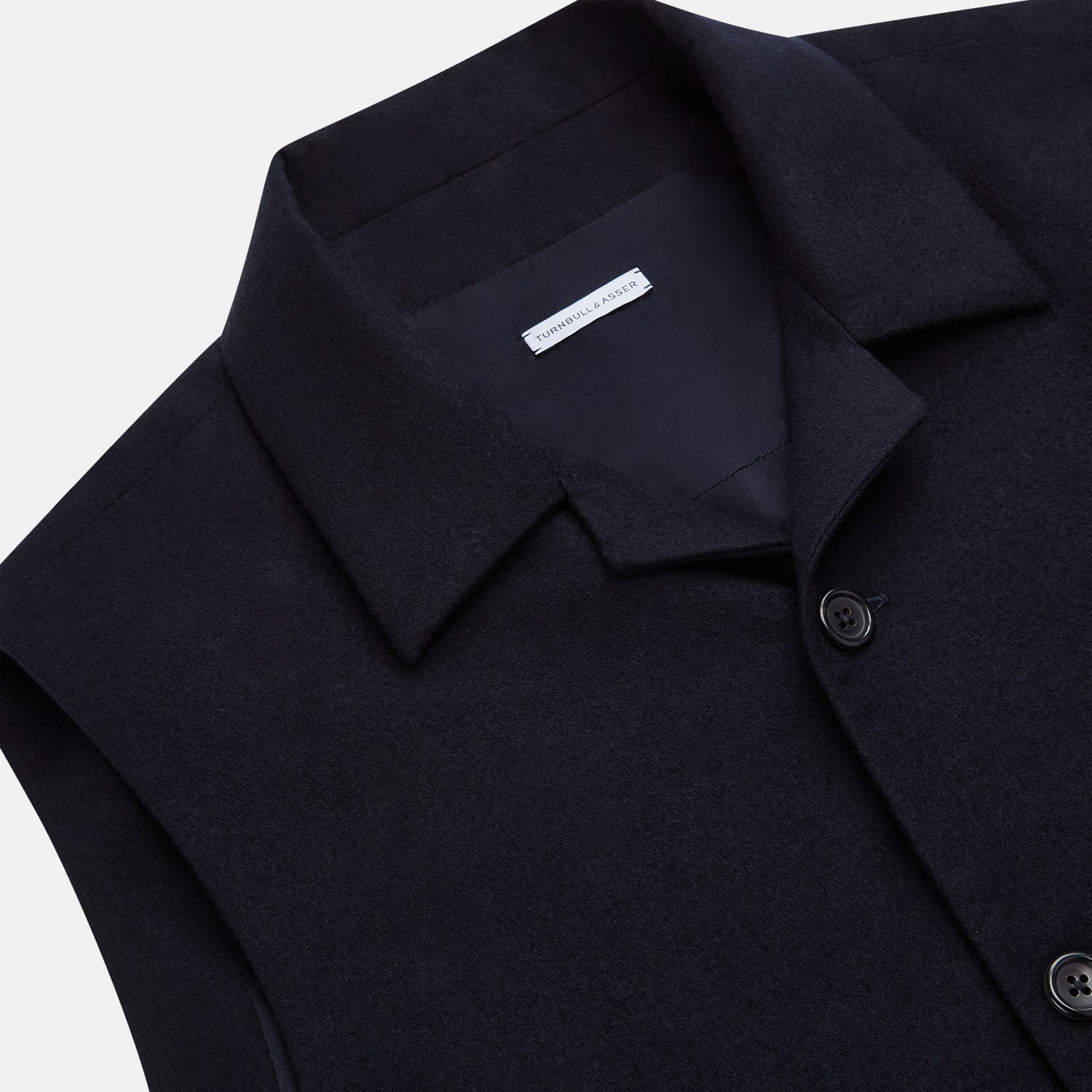 View 2 of product The Turnbull & Asser Navy Collared Single-breasted Waistcoat features a sleeveless design, wool-cashmere blend, two zippered side pockets, and a chest pocket—ideal for upgrading your winter look—shown on a white background.