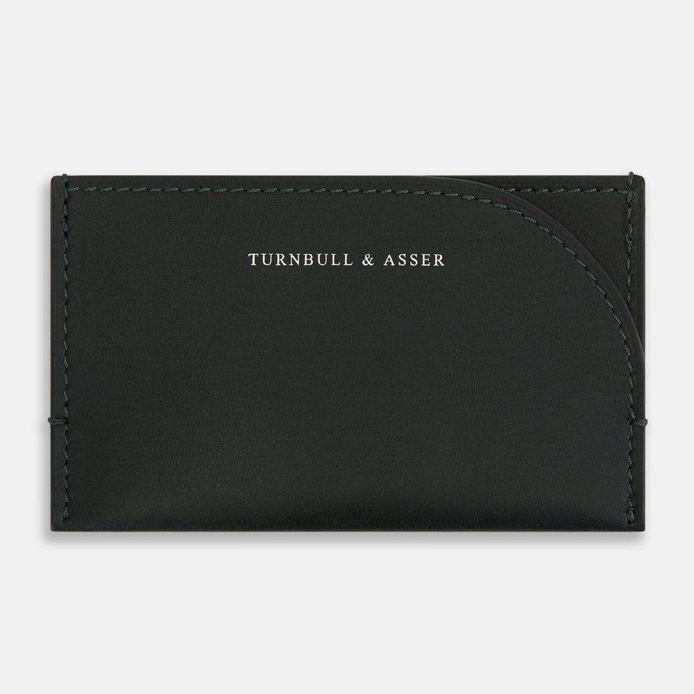 A forest green slim leather card case by Turnbull & Asser with the brand name in white on the front, visible stitching, and a curved pocket design on the right side.