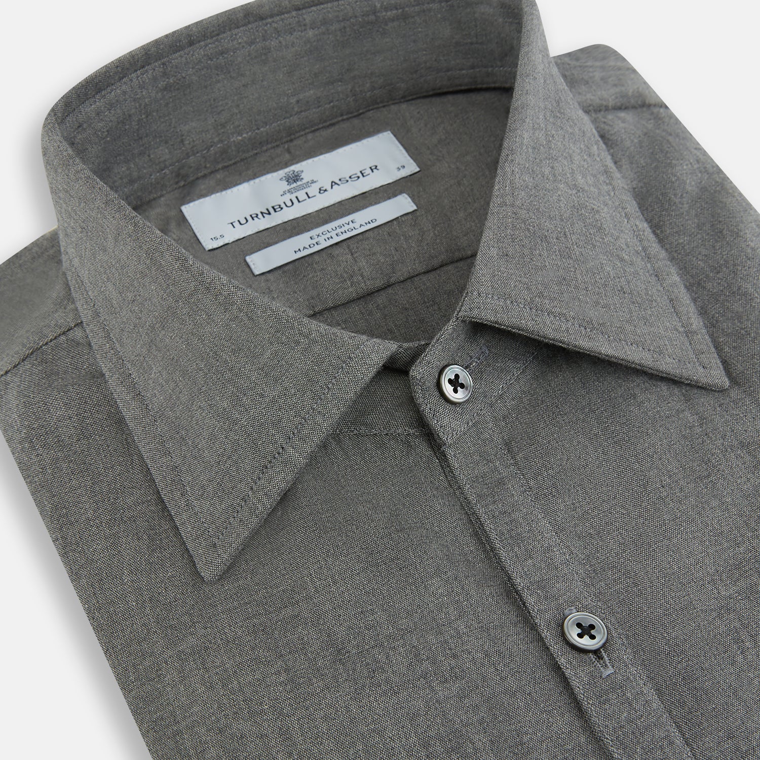 View 2 of product The Pale Charcoal Westminster Shirt by Turnbull & Asser features British craftsmanship with a tailored silhouette, long sleeves, pointed collar, buttoned cuffs, and a solid pale charcoal hue, elegantly shown against a white background.
