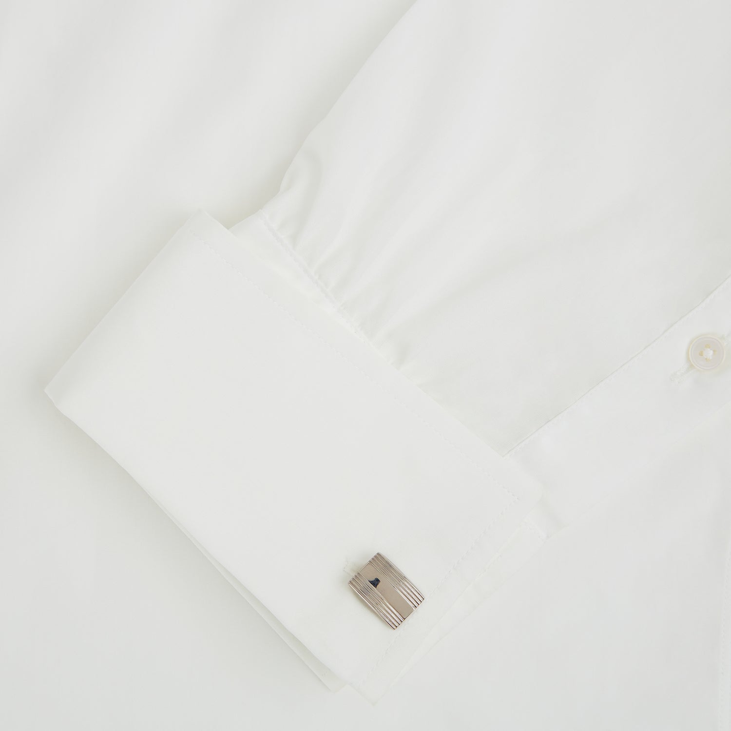 View 3 of product Turnbull & Asser Silver Striped Rectangular Cufflinks feature a subtle horizontal engraved line pattern on the front, set against a white background.
