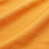 View 7 of product A man stands against a tan background, wearing a Turnbull & Asser Orange Weekend Fit Cotton & Wool Shirt with Derby Collar and 1 Button Cuffs, tucked into dark blue dress pants with a black belt and shoes. He has one hand in his pocket.
