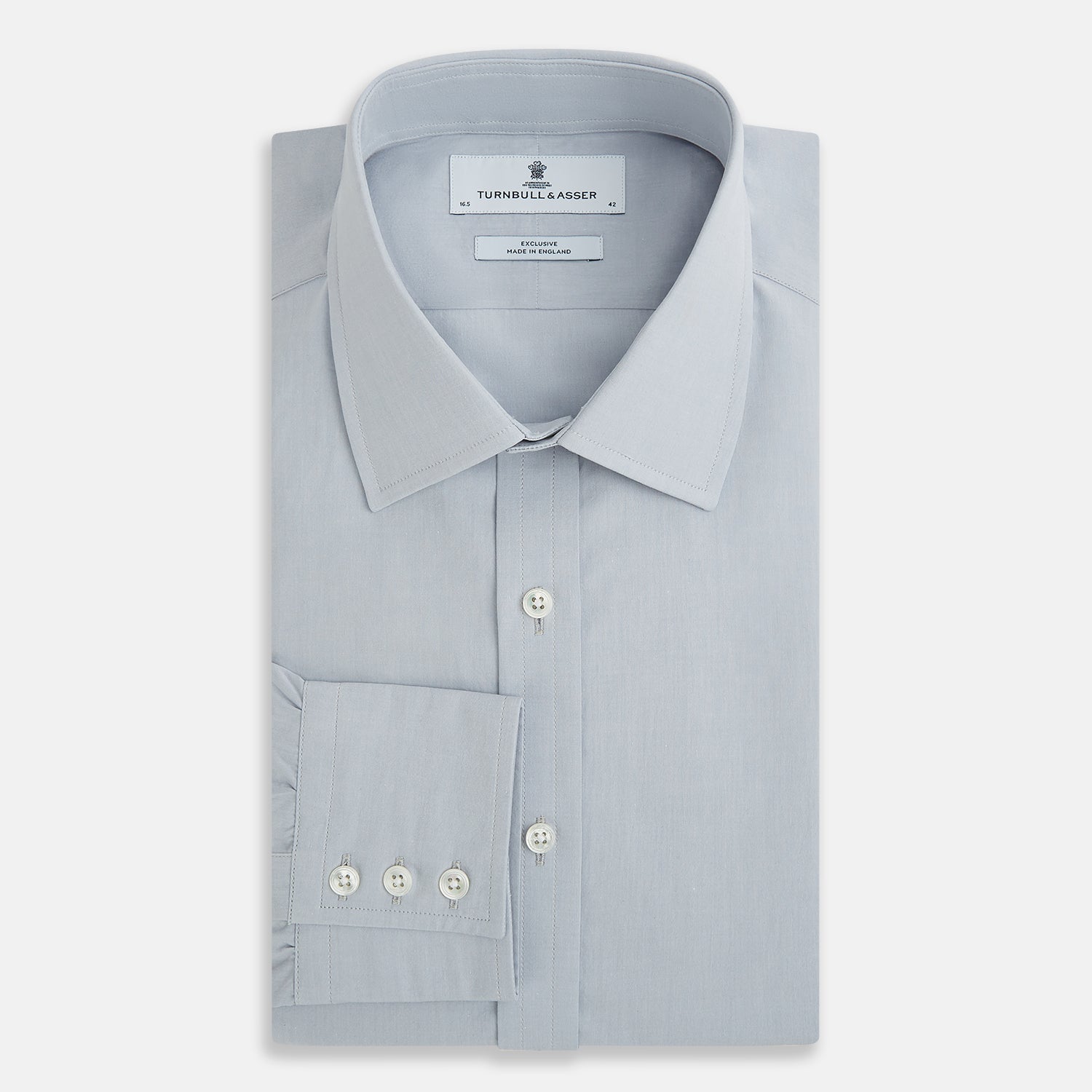 View 5 of product The Dove Grey Mayfair Shirt by Turnbull & Asser is a long-sleeve button-up with a collar, front pocket, and white buttons, crafted from soft sanforised cotton and laid flat on a white background.