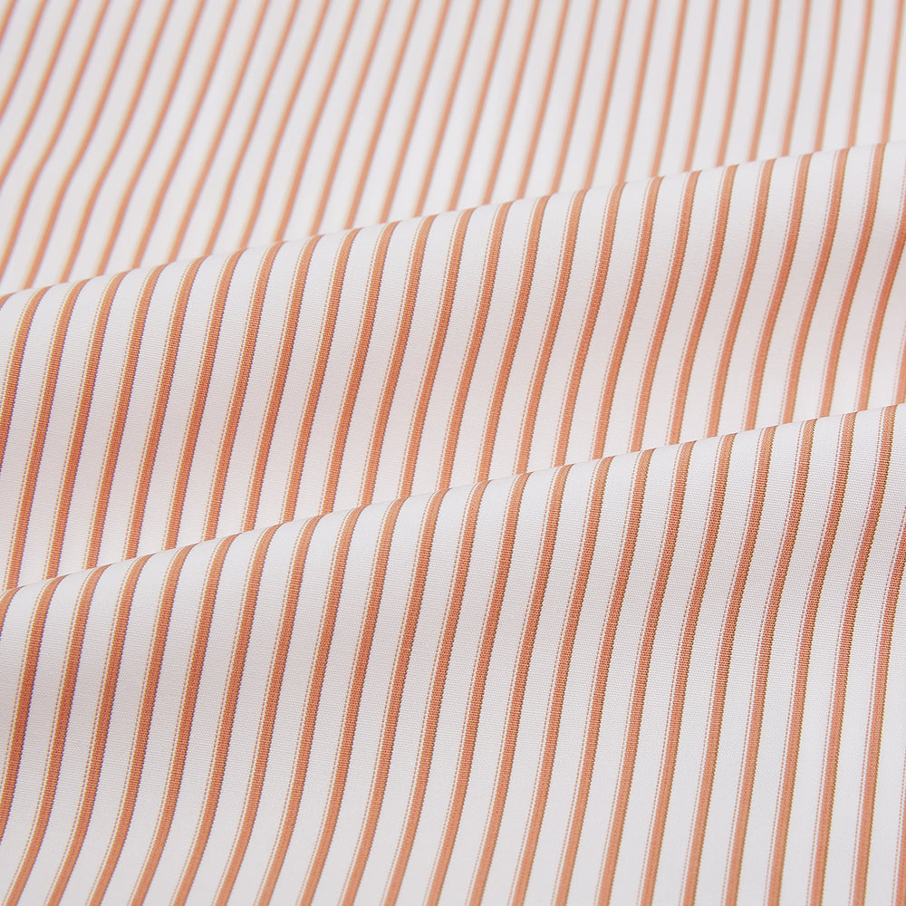 The Orange Multi Stripe Westminster Shirt by Turnbull & Asser features thin vertical orange and white stripes, a Turnbull collar, and long sleeves, elegantly displayed flat against a white background.