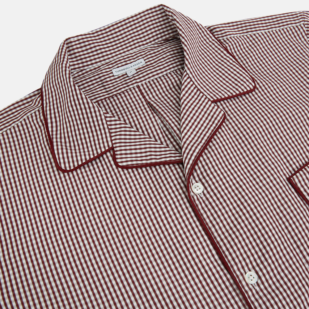 The Turnbull & Asser Burgundy Micro Check Winston Long Nightshirt is knee-length with long sleeves, brown and white micro checks, a collar, chest pocket with piping, and a front button placket.