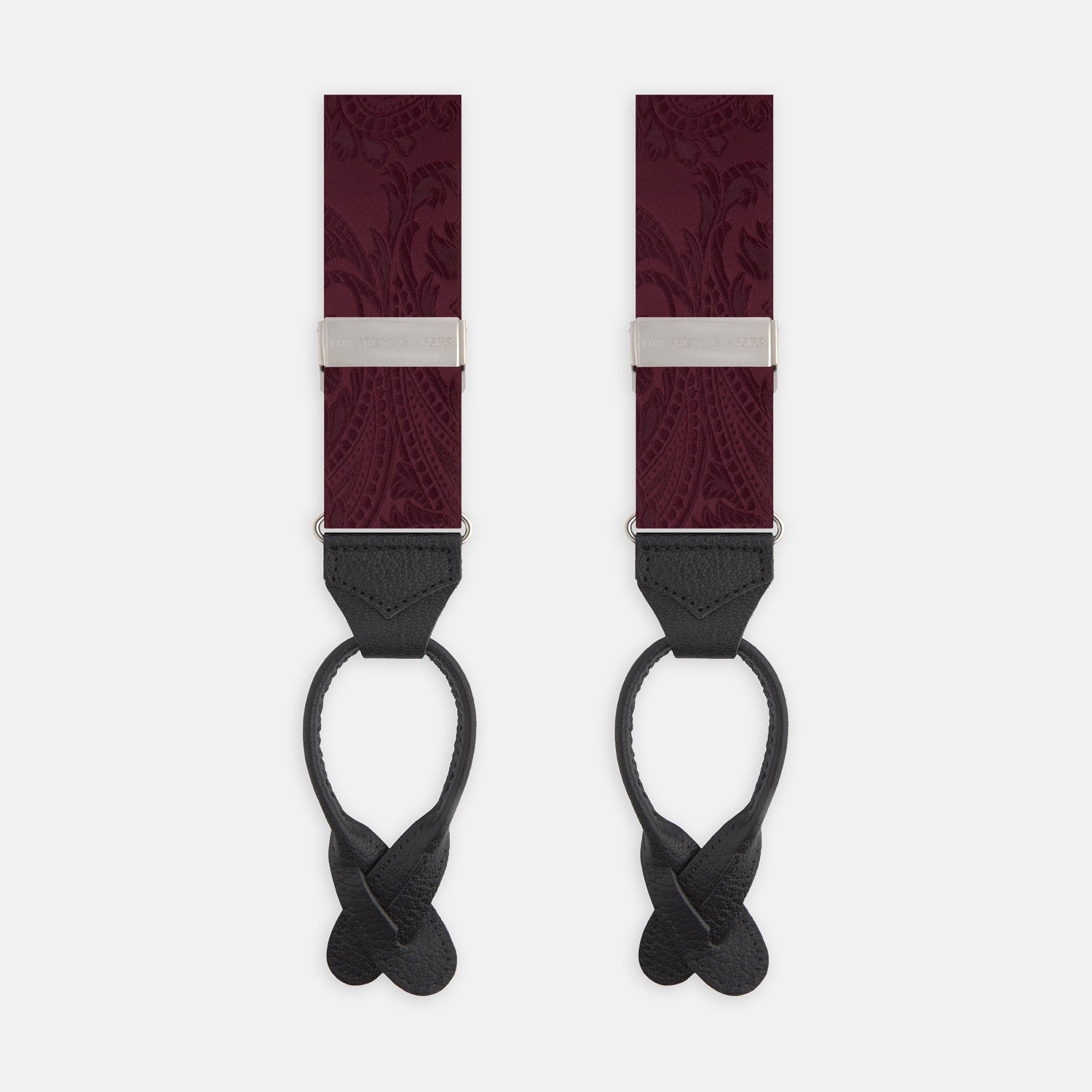 View 1 of product The Turnbull & Asser Burgundy Paisley Adjustable Silk Braces feature black leather loops and silver adjusters, shown on a plain white background.