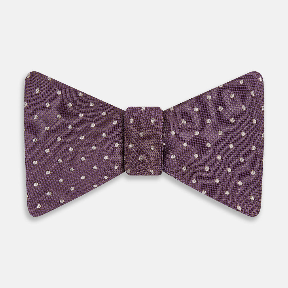 The Turnbull & Asser Lilac and Purple Micro Dot Silk Bow Tie, shown on a plain white background, features tiny white dots—a stylish accessory to enhance any men's outfit.