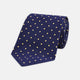 The Turnbull & Asser Navy Spot Woven Herringbone Silk Tie features a navy blue base with evenly spaced yellow polka dots, making it an essential accessory for smart attire. Displayed rolled on a white background.