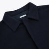 View 2 of product The Turnbull & Asser Navy Greenwich Knitted Overshirt, made from Italian wool with a collar, two front flap pockets, and a hidden button placket, is shown laid flat on a white background.
