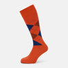 View 1 of product Turnbull & Asser's Royal Blue and Orange Patterned Mid-Length Socks feature an argyle design with brown, blue, and orange diamonds, shown against a plain white background.