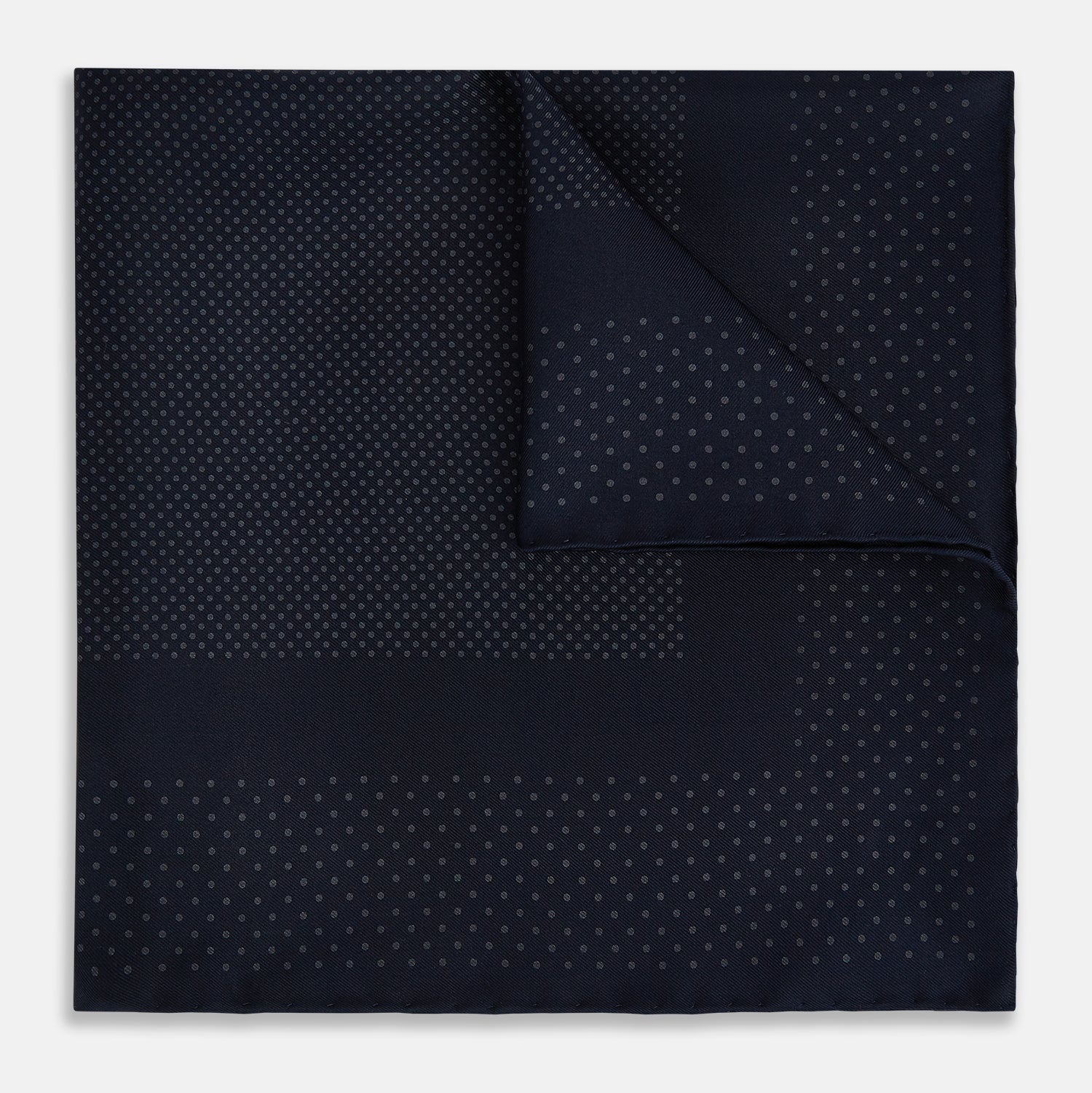 View 1 of product The Turnbull & Asser Navy and Charcoal Dot Silk Pocket Square features a subtle dotted pattern and a folded corner, shown on a white background.