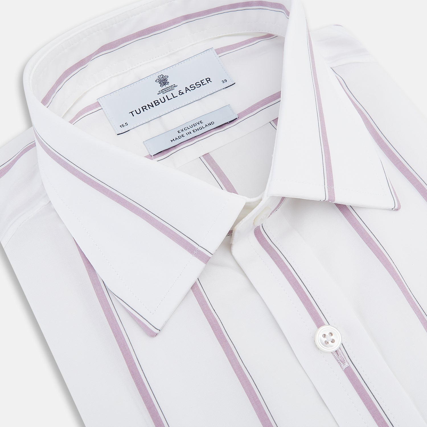 View 2 of product The Turnbull & Asser Antique Pink Track Stripe Mayfair Shirt is a white, long-sleeved Italian cotton shirt with vertical pink stripes, a spread collar, and buttoned cuffs, shown laid flat on a white background.