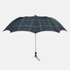 View 1 of product The Colquhoun Tartan Telescopic Umbrella by Turnbull & Asser features a green, blue, and red plaid canopy, silver metal shaft, and brown maple handle with wrist strap. Shown fully open against a plain white background.