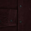 View 4 of product The Turnbull & Asser Burgundy Corduroy Hampstead Overshirt features long sleeves, a collar, a large left chest pocket, and two zippered side pockets, shown laid flat on a plain white background.