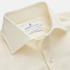 View 2 of product The Turnbull & Asser Tailored Fit Cream Cotton Shirt features a Kent collar and 3-button cuffs, shown against a plain white background.