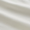 View 5 of product The Women's Harriet Cream Silk Pyjama Set by Turnbull & Asser features a white sand-washed silk button-up top with black piping and chest pocket, plus matching drawstring pants, all shown against a white background.