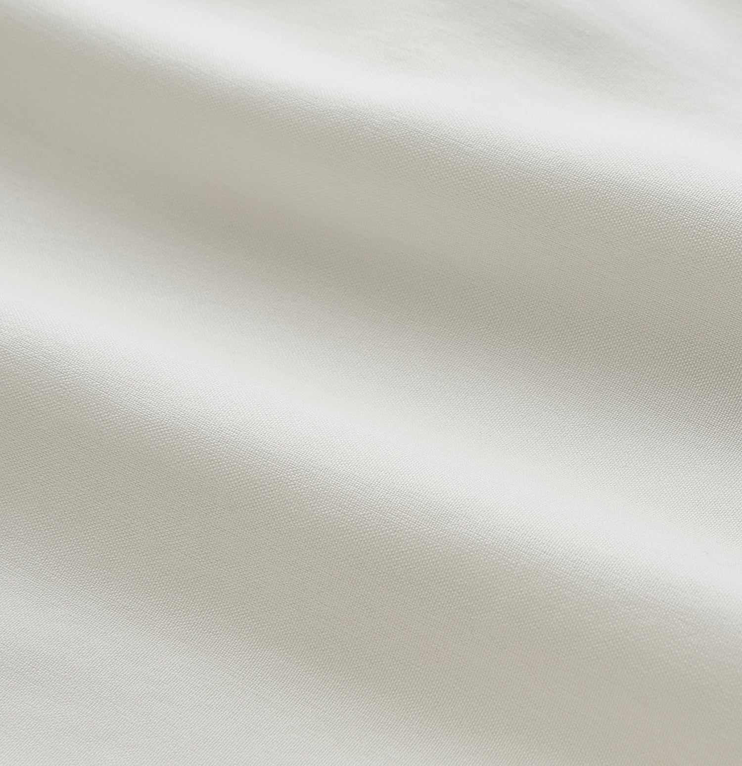 View 5 of product The Women's Harriet Cream Silk Pyjama Set by Turnbull & Asser features a white sand-washed silk button-up top with black piping and chest pocket, plus matching drawstring pants, all shown against a white background.
