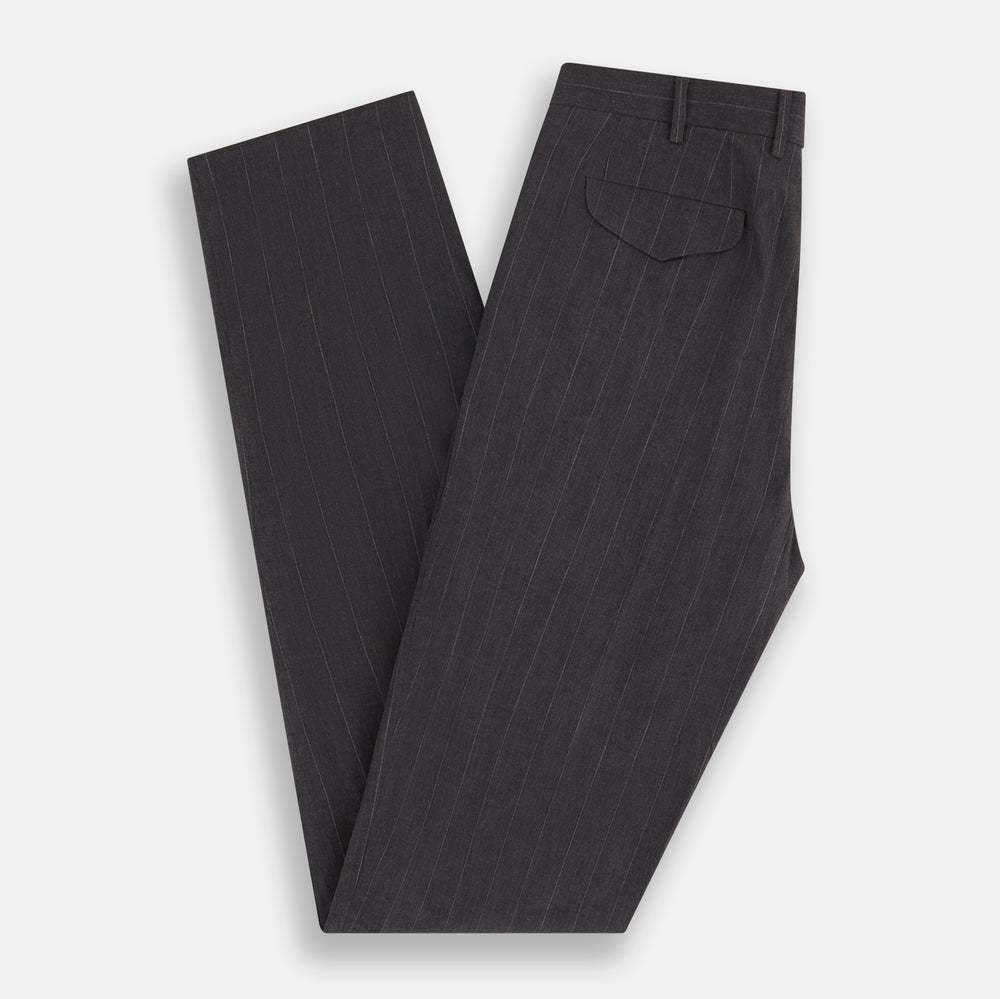 Turnbull & Asser’s Dark Chocolate Striped Edmund trousers feature straight-cut legs, a relaxed fit, button closure, and belt loops. These cotton trousers display subtle vertical stripes against a plain white background.