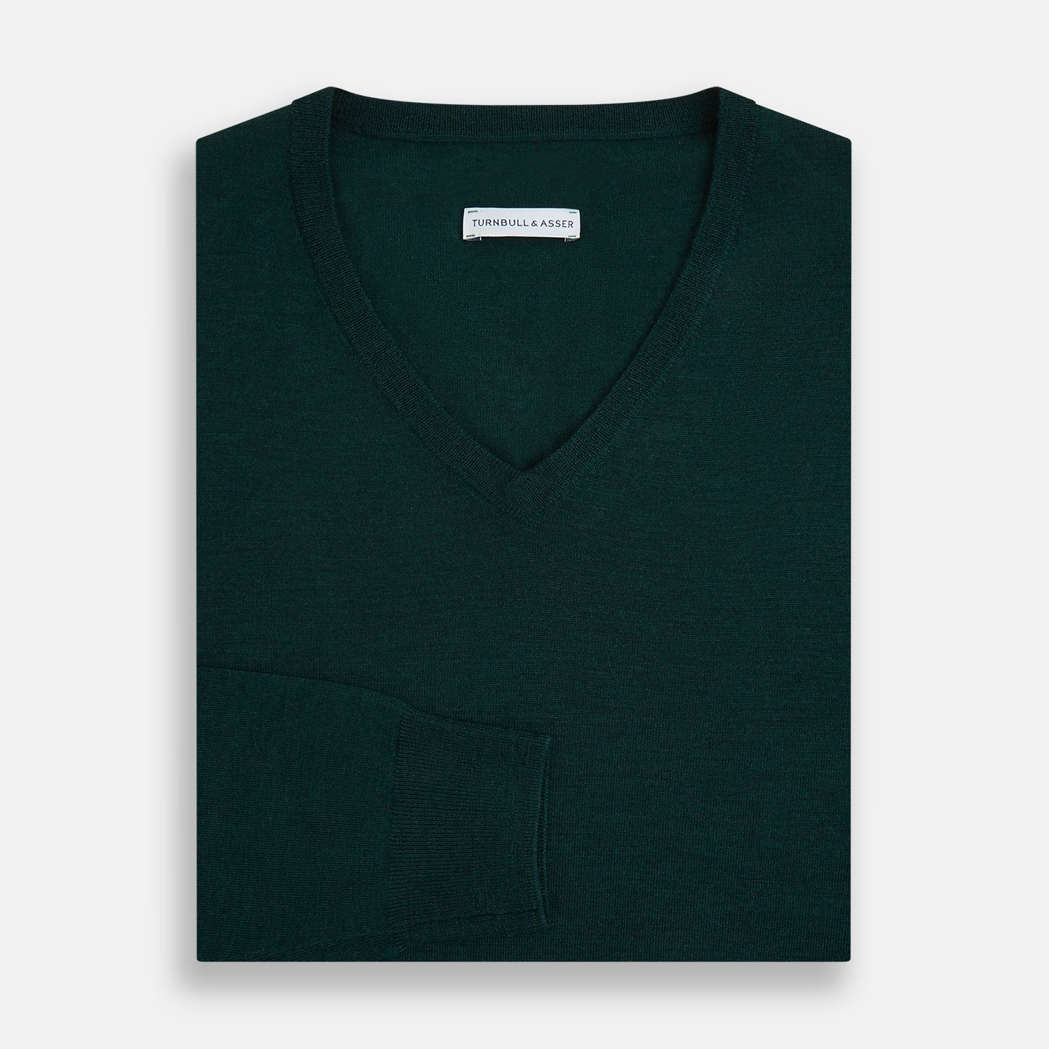 View 4 of product The Turnbull & Asser Petrol Green Merino V-Neck Jumper features long sleeves and ribbed cuffs and hem—an essential knitwear piece, shown against a white background.