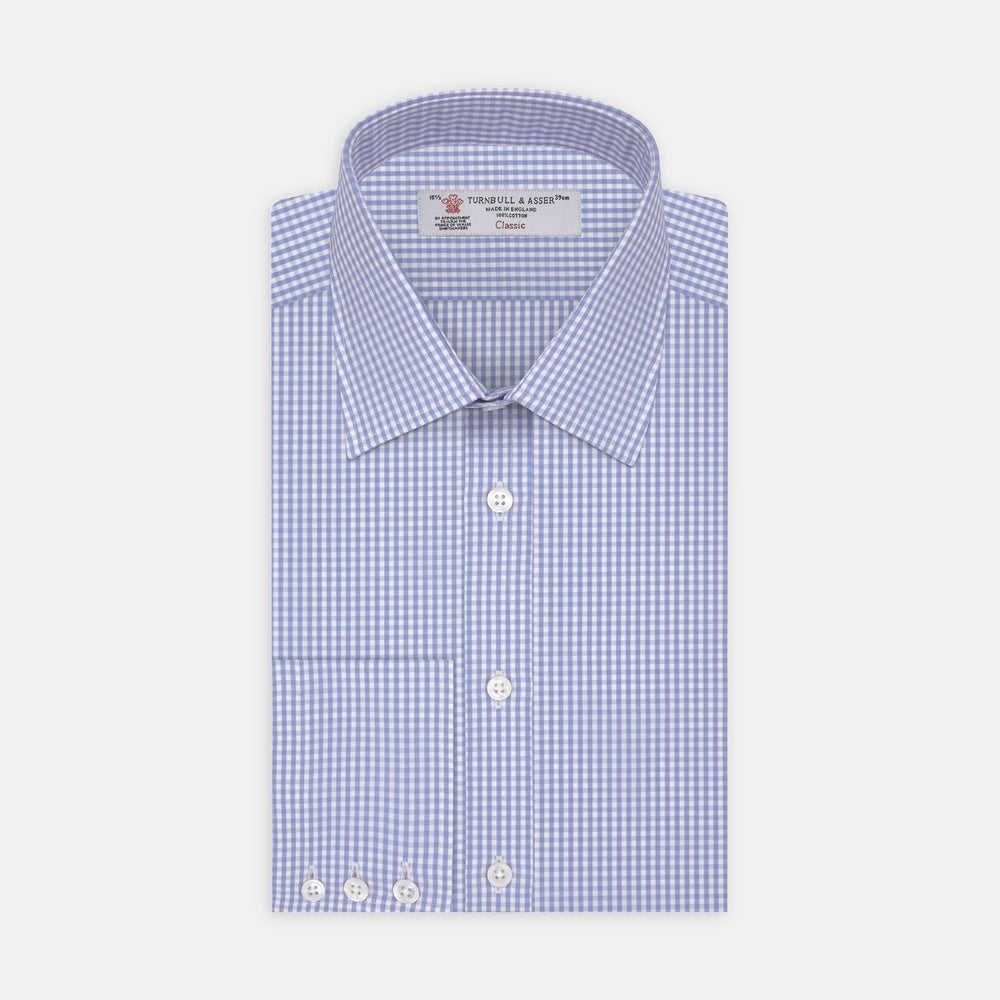A circular swatch of Turnbull & Asser's Light Blue Gingham Check Cotton Fabric, featuring a simple light blue and white checkered pattern, is bordered by a thin gray outline on a white background.