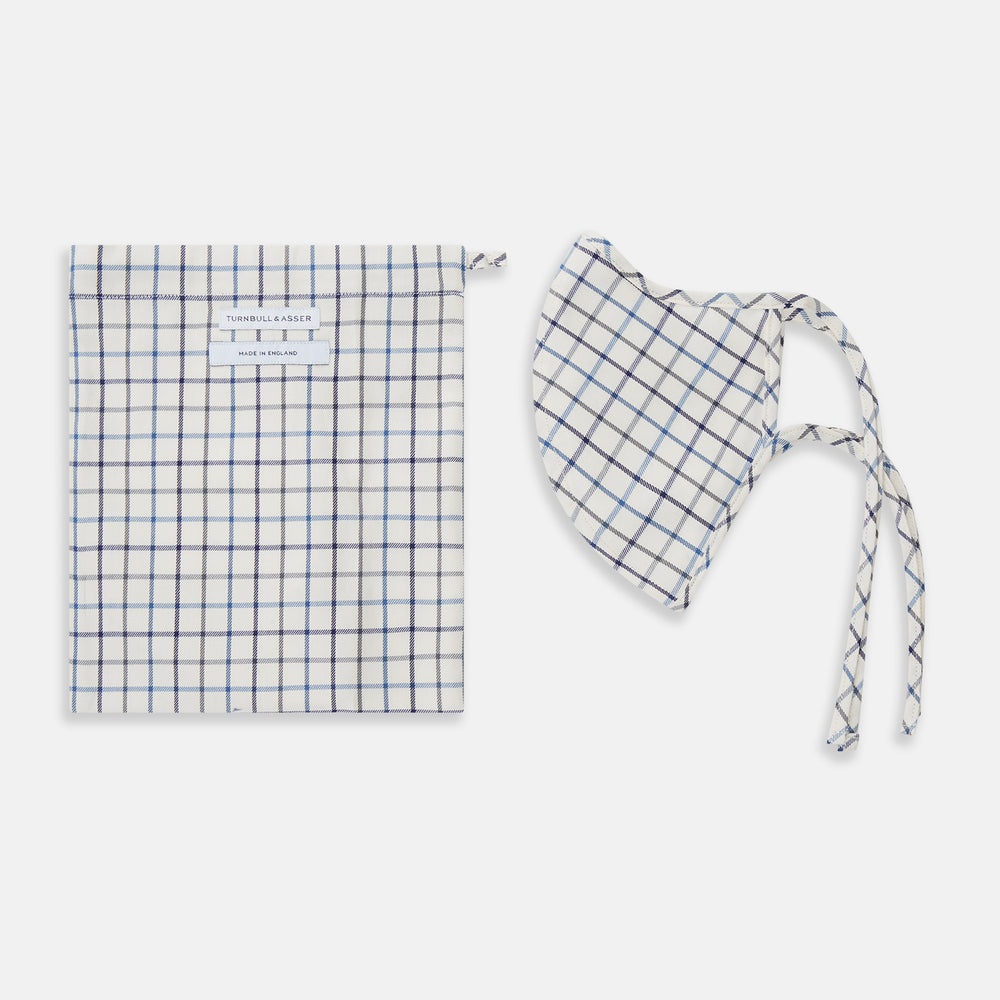 The Turnbull & Asser Check Blue Multi Commuter Mask features a blue plaid design, adjustable fabric ear loops tied in bows, and comes with 3 Viroformula™ filters. Laid flat on a white background.