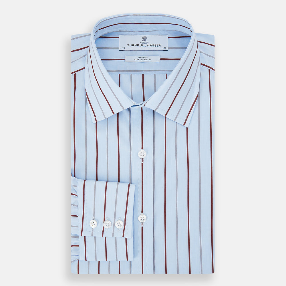 The Turnbull & Asser Burgundy Wide Pinstripe Mayfair Shirt features a collared, long-sleeve design with bold vertical stripes, crafted in the refined Mayfair fit and displayed on a plain white background.