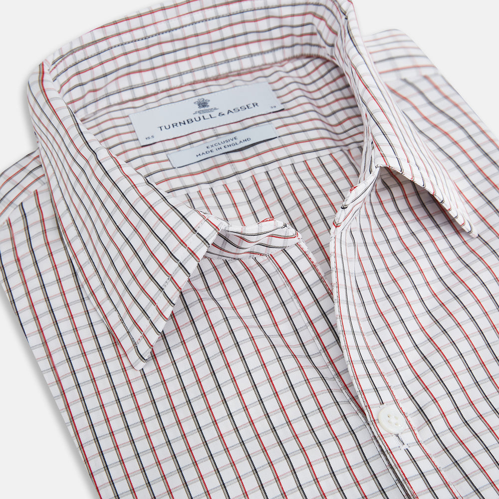 The Turnbull & Asser Red and Midnight Blue Tattersall Check Windsor Shirt features British craftsmanship, shown laid flat with sleeves extended and collar neatly folded.