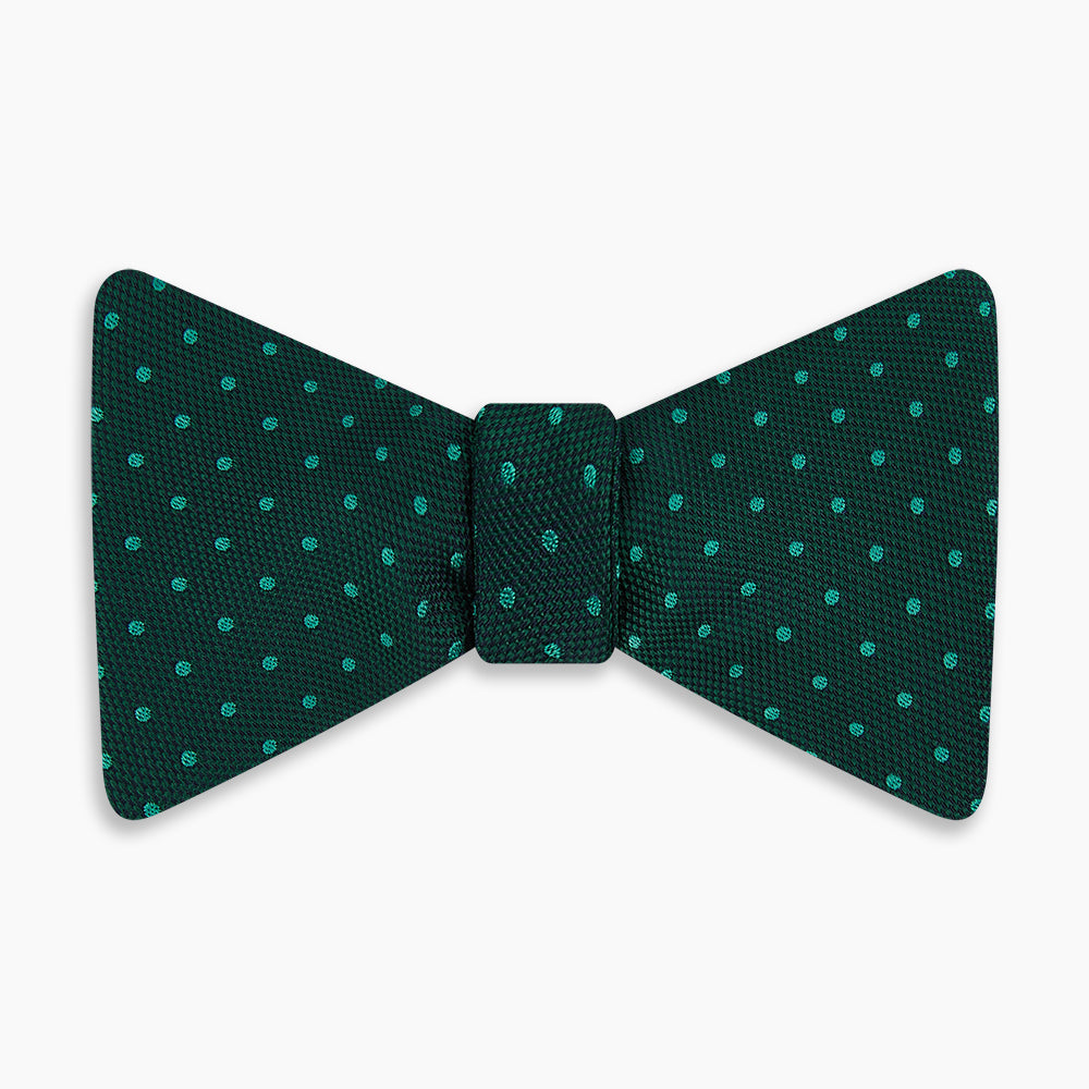 The Turnbull & Asser Dark Green and Navy Micro Dot Silk Bow Tie, featuring a refined dotted pattern, is showcased on a plain white background—an elegant accessory perfect for any occasion.