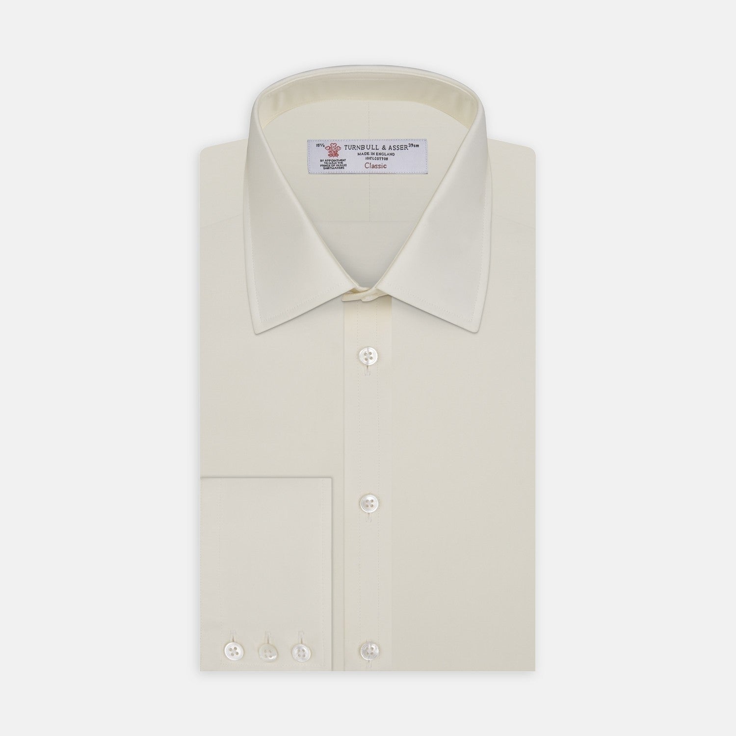 View 2 of product A close-up of Turnbull & Asser's Cream Cotton Fabric, framed by a circular gray border. The smooth cotton shows a subtle seam on the right, highlighting the product's fine texture and quality.