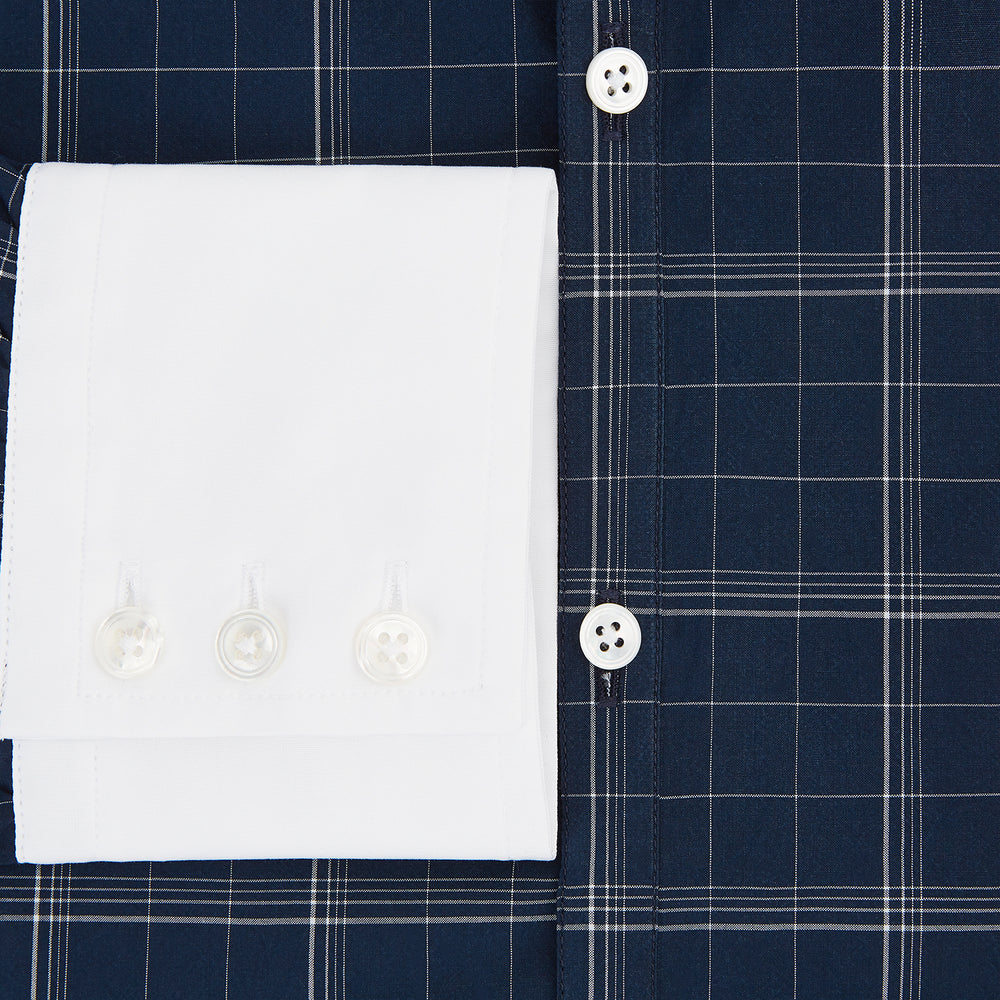 The Turnbull & Asser Indigo Windowpane Check Windsor Shirt features a contrast T&A collar and cuffs, highlighting British craftsmanship. It is displayed flat on a white background.