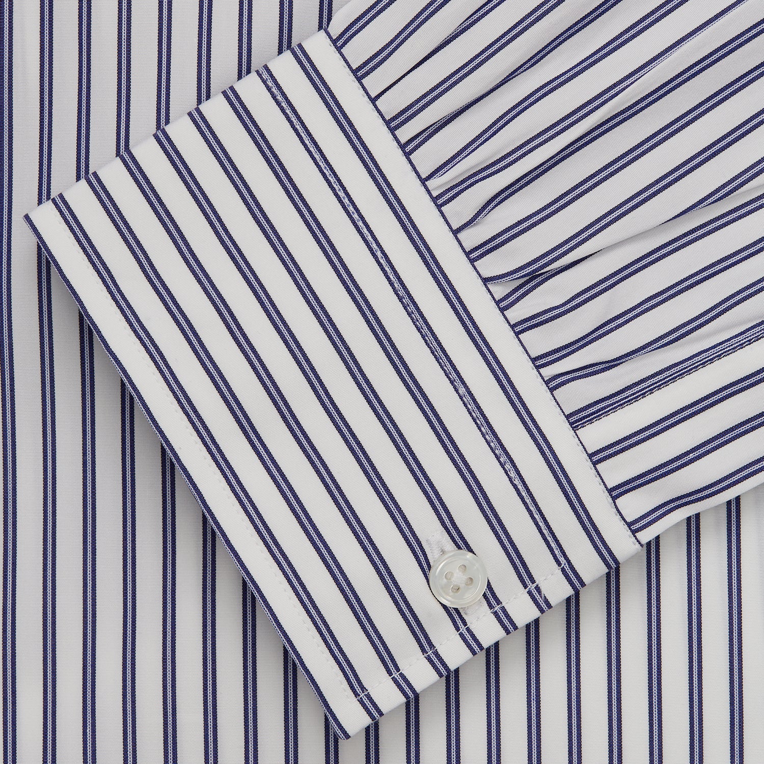 View 3 of product The Turnbull & Asser Navy Stripe Weekend Fit Shirt features a Derby collar, vertical navy and white stripes, 1-button cuffs, a chest pocket, and a regular fit, shown laid flat against a white background.