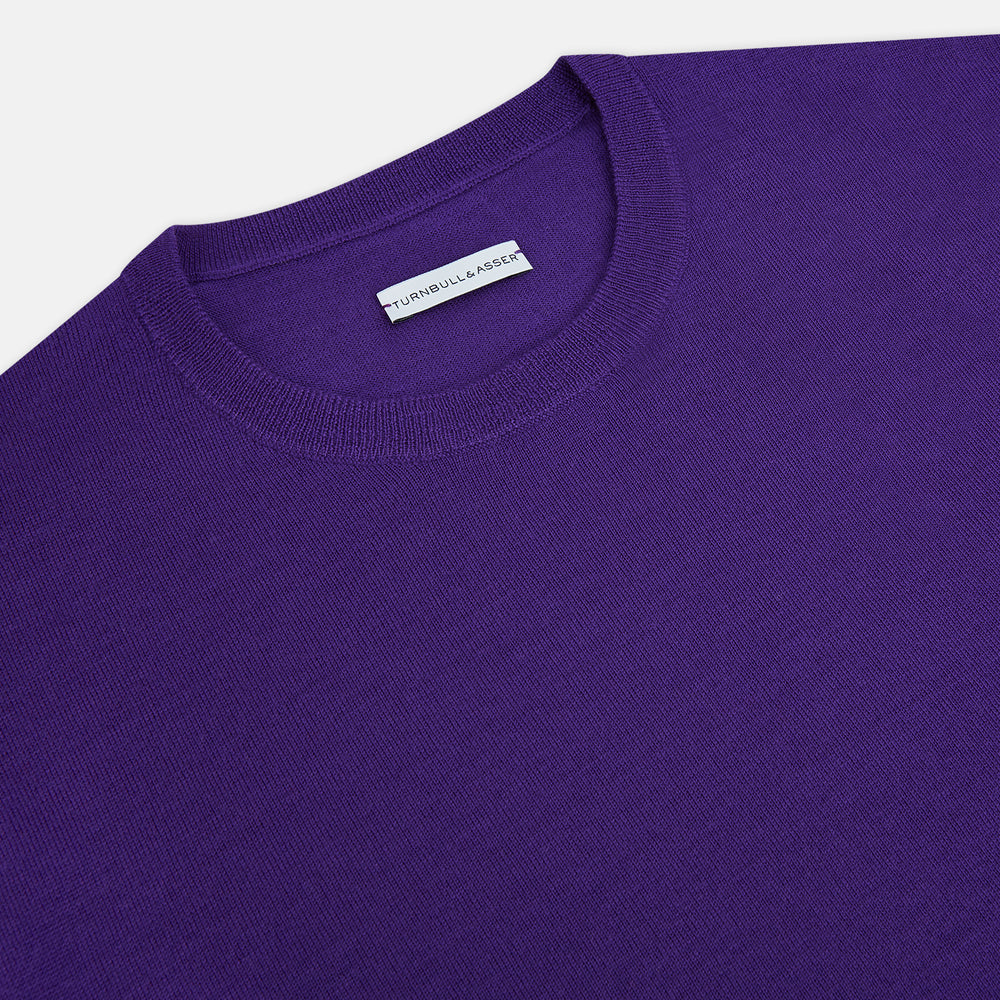The Turnbull & Asser Purple Merino Round Neck Jumper, a classic men’s knitwear piece, is shown against a white background.