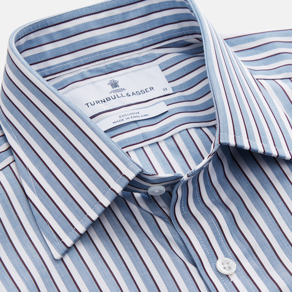 The Turnbull & Asser Blue and White Stripe Cotton Regular Fit Mayfair Shirt features long sleeves, a button-up front, collar, buttoned cuffs, and vertical stripes, shown on a white background.