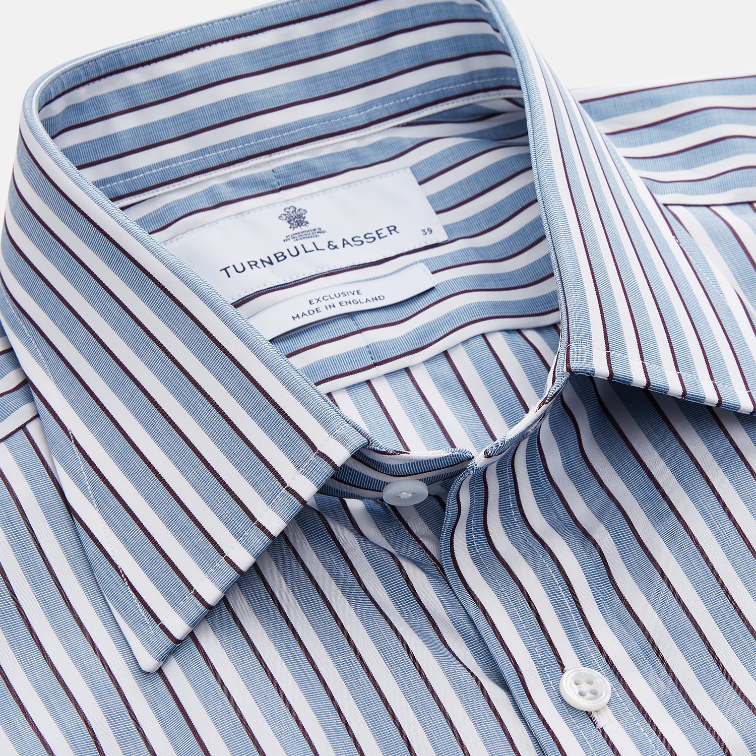 View 2 of product The Turnbull & Asser Blue and White Stripe Cotton Regular Fit Mayfair Shirt features long sleeves, a button-up front, collar, buttoned cuffs, and vertical stripes, shown on a white background.
