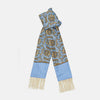 View 1 of product The Turnbull & Asser GGSC3128 5665 06 OS is a blue paisley silk scarf with ornate gold designs, solid light blue ends, and cream fringes. Shown laid flat with one end folded, it highlights its luxurious style.