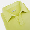 View 2 of product The Turnbull & Asser Lime Green Rugby Polo Shirt is a pure cotton, long-sleeve shirt with a collar and no visible buttons, displayed flat against a white background.