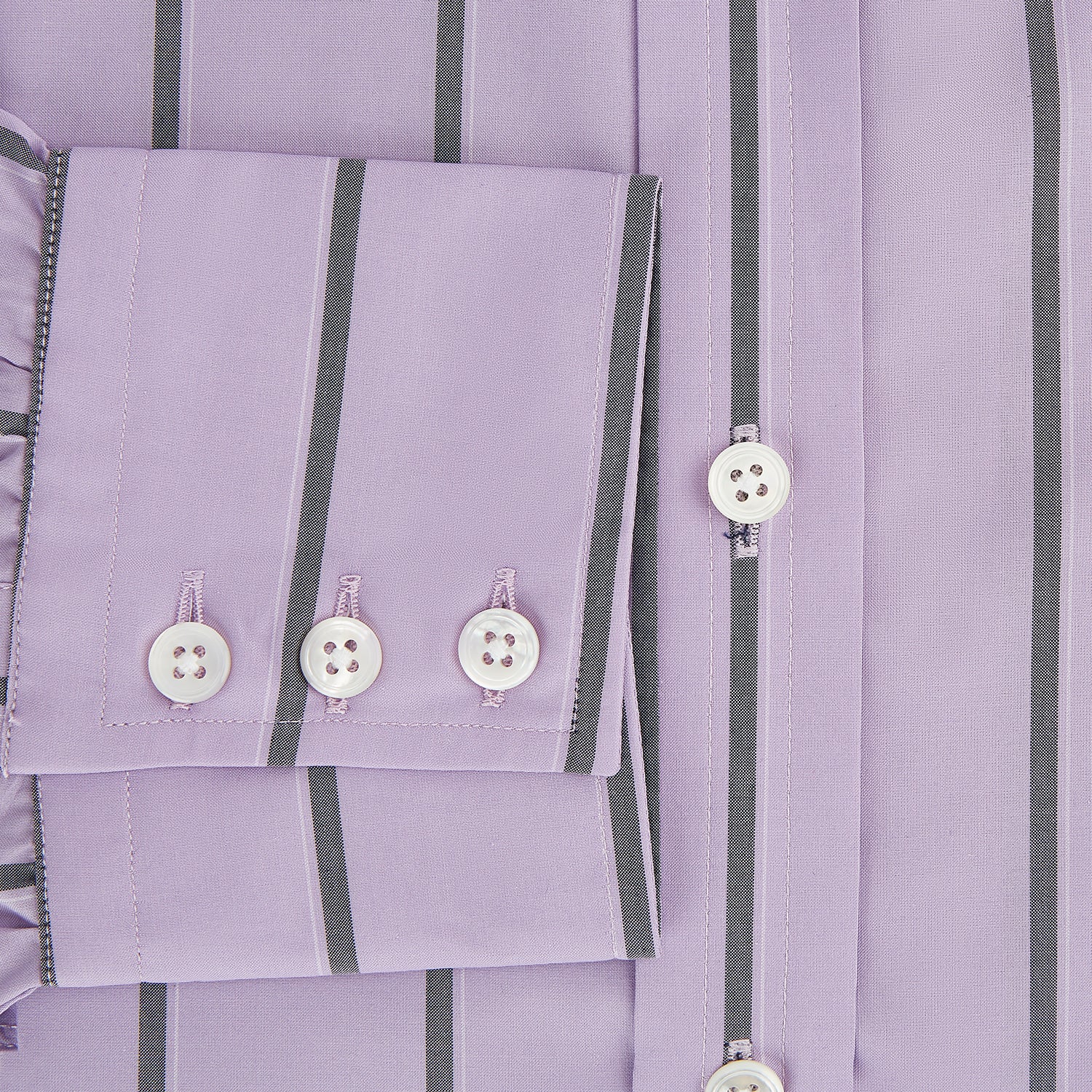 View 4 of product The Turnbull & Asser Lilac Track Stripe Mayfair Shirt is a long-sleeve Italian cotton shirt in light purple with dark lilac vertical stripes, shown laid flat on a white background.