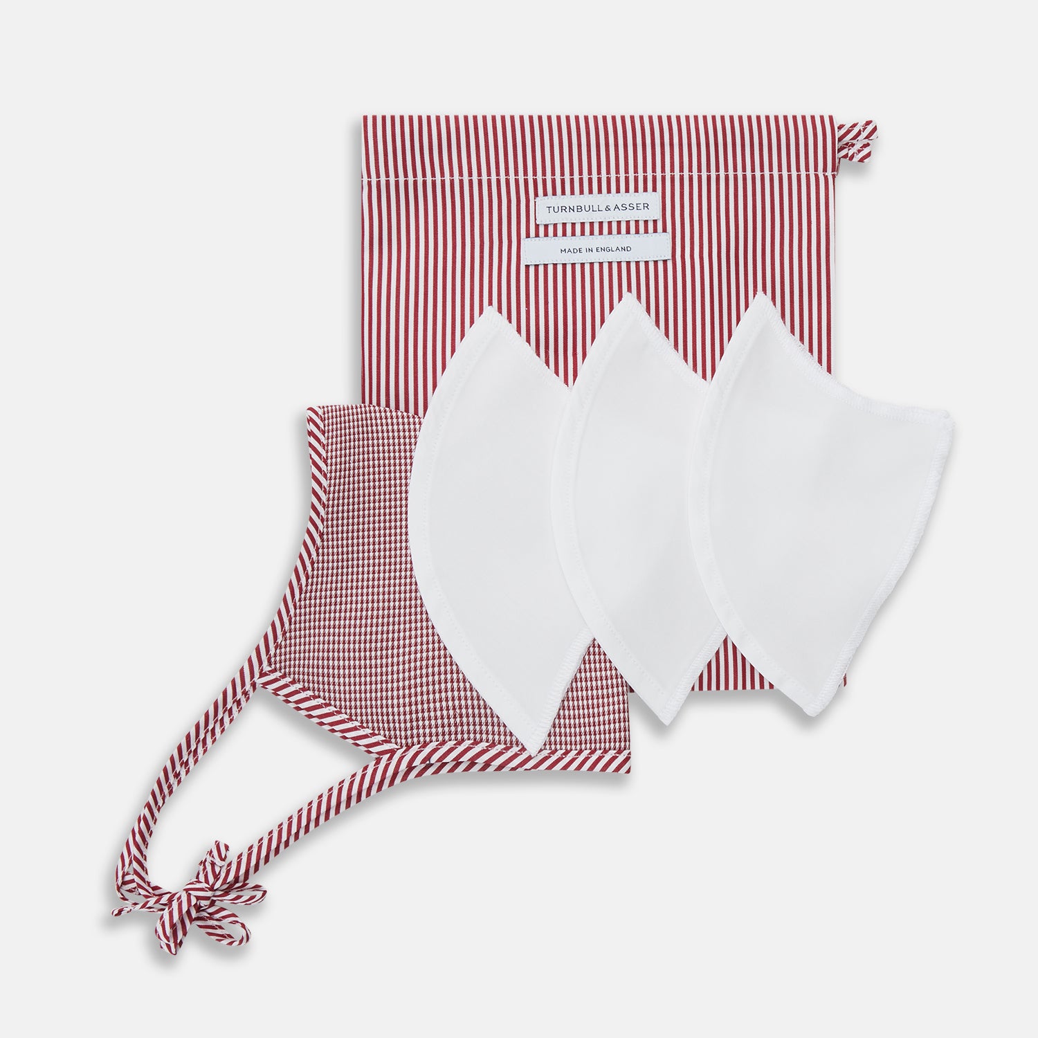 View 6 of product The Turnbull & Asser Burgundy Check Commuter Mask comes with 3 Viroformula™ filters. It features a check pattern, adjustable ear straps, and is displayed on a plain white background.