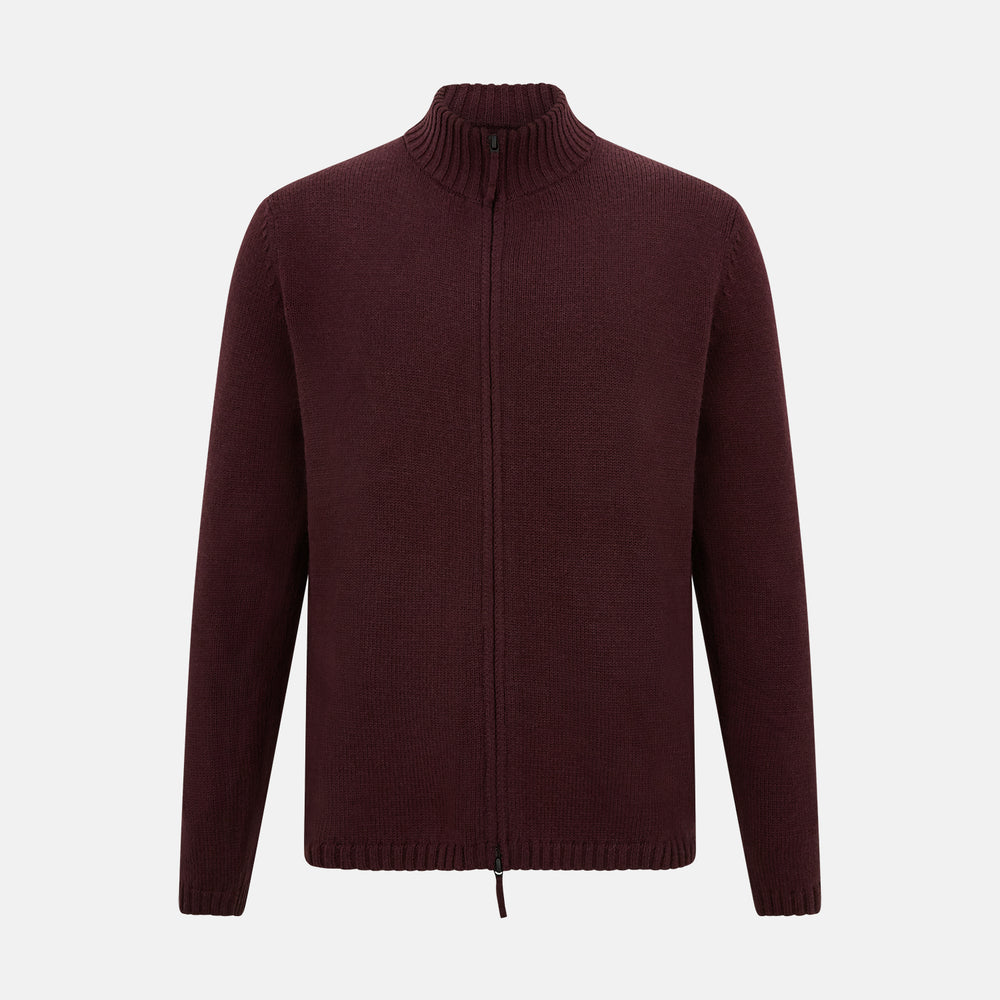The Turnbull & Asser Burgundy Merino High Neck Zipped Cardigan features long sleeves, a zip-up front, and ribbed collar, cuffs, and hem, crafted from soft merino knitwear and shown on a white background.