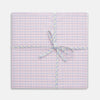 View 1 of product A neatly wrapped square gift box featuring Turnbull & Asser's Yellow and Red Cotton RE-PURPOSE Handkerchiefs 3-pack, tied with a matching plaid ribbon in a bow at the center, set against a white background.