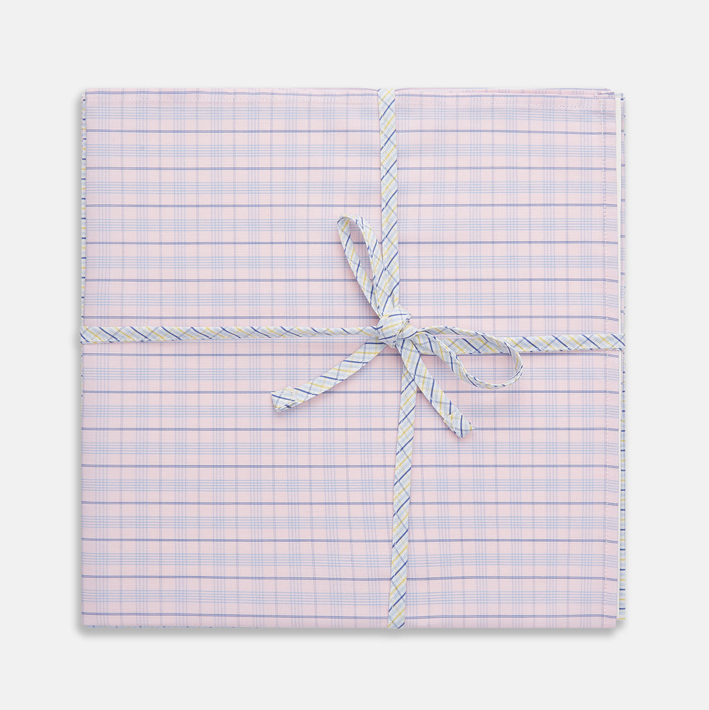A neatly wrapped square gift box featuring Turnbull & Asser's Yellow and Red Cotton RE-PURPOSE Handkerchiefs 3-pack, tied with a matching plaid ribbon in a bow at the center, set against a white background.