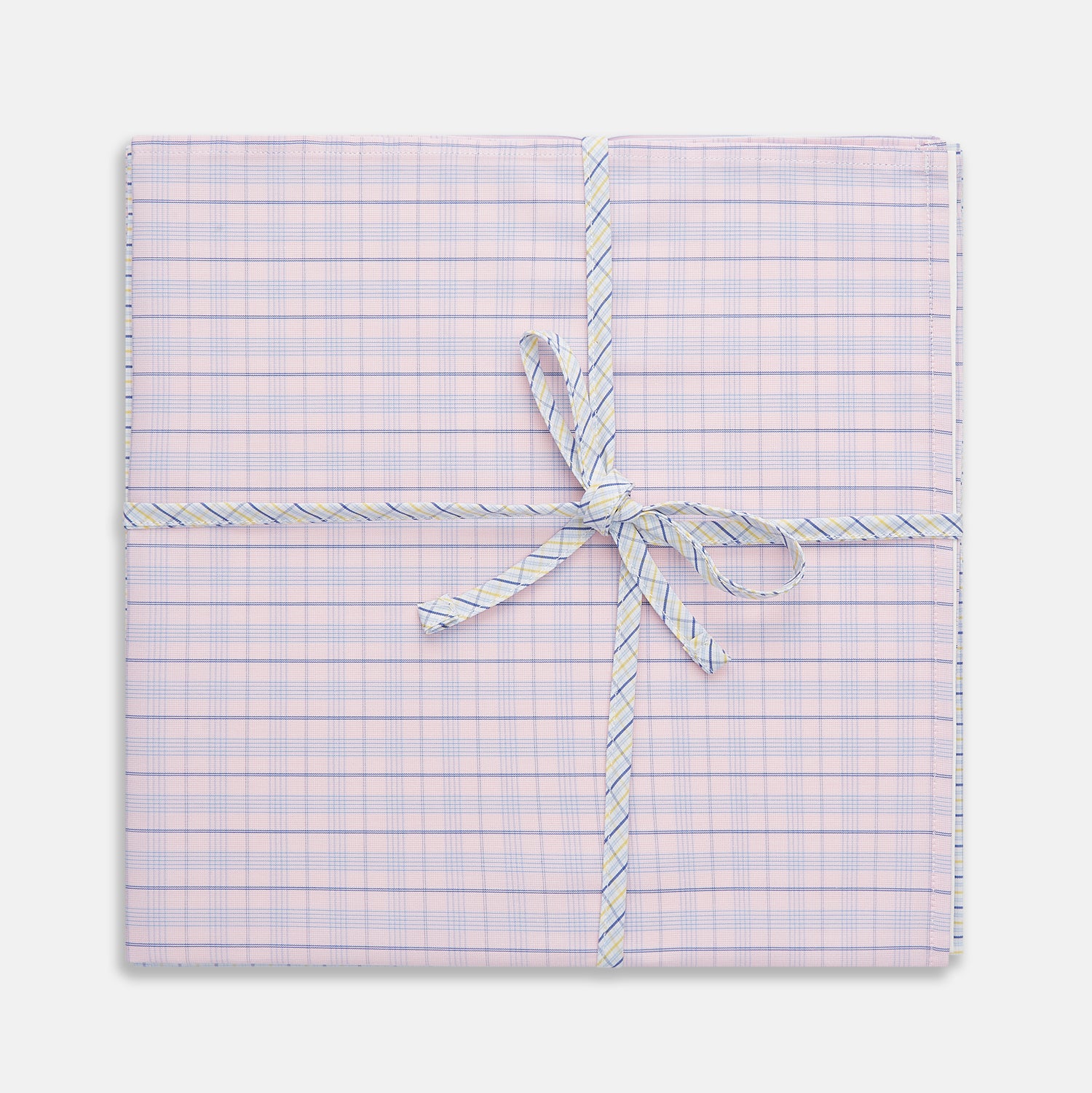 View 1 of product A neatly wrapped square gift box featuring Turnbull & Asser's Yellow and Red Cotton RE-PURPOSE Handkerchiefs 3-pack, tied with a matching plaid ribbon in a bow at the center, set against a white background.