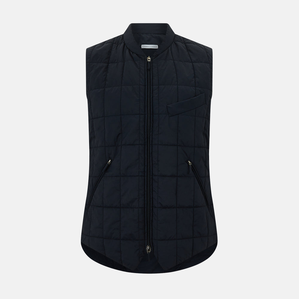 The Turnbull & Asser Navy Quilted Gilet is sleeveless and lightweight, with a front zipper, zippered side pockets, chest pocket, and rounded hem—ideal for versatile layering. Shown on a plain white background.