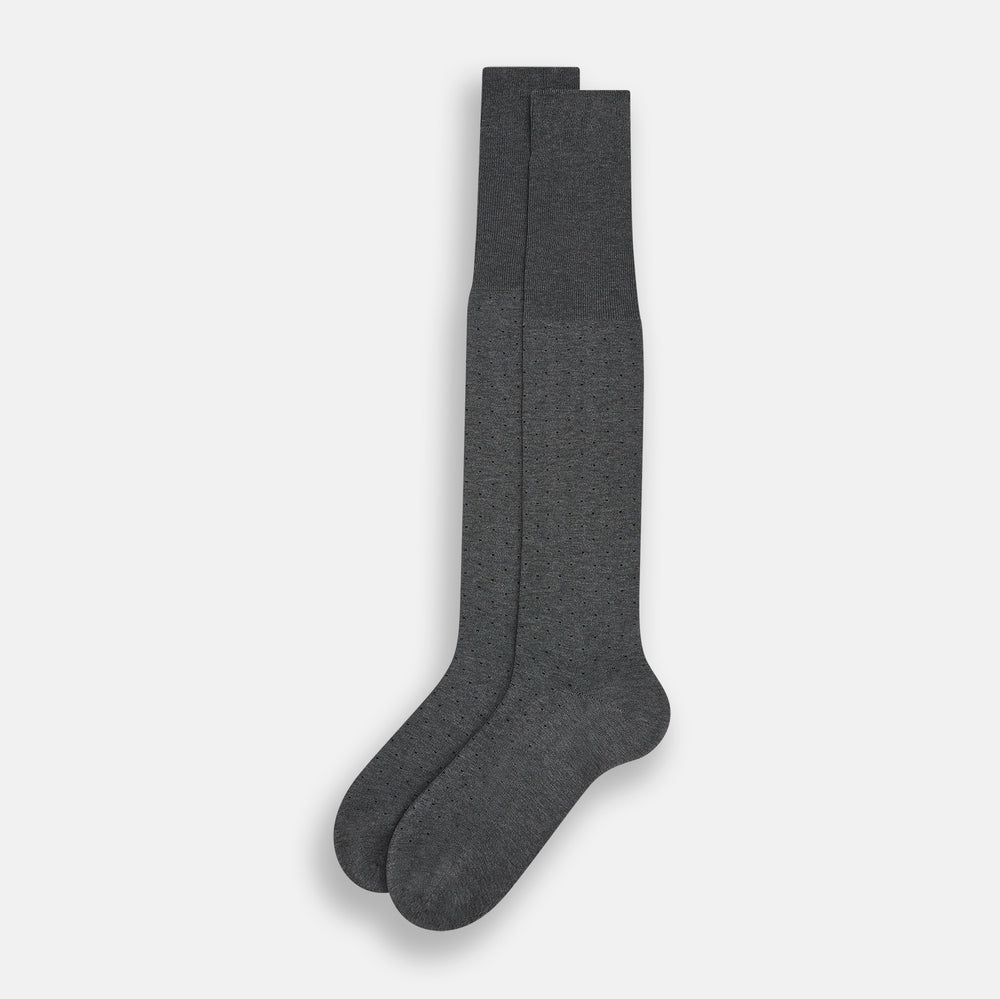 The Turnbull & Asser Steel/midnight Polka Dot Long Sock is shown in dark gray over the calf, displayed from the side on a white background with downward toe and ribbed top for a snug fit.