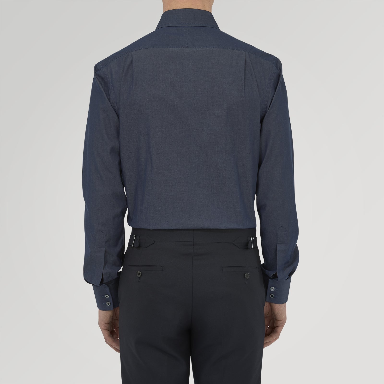 View 3 of product A neatly folded Turnbull & Asser Dark Blue Denim-Cashmere Shirt with a T&A collar and double cuffs, featuring black buttons, shown on a white background. The label inside the collar highlights its smart finish and refined style.