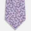View 3 of product The Turnbull & Asser Multi-coloured Circle Lilac Silk Tie features overlapping blue, purple, and white circles on fine English silk—ideal for elevating smart outfits. Shown rolled against a plain white background.